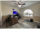 Office with a large desk, ceiling fan, and a unique arched window providing natural light at 4615 E Emerald Ave, Mesa, AZ 85206