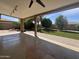 Covered patio leading to a lush backyard with mature trees and brick pavers at 4615 E Emerald Ave, Mesa, AZ 85206
