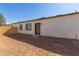 Spacious backyard featuring a newly-installed wooden fence, a stucco wall, and a brown door at 463 W Taylor Ave, Coolidge, AZ 85128