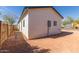 Backyard featuring a newly-installed wooden fence, stucco wall, and small walkway at 463 W Taylor Ave, Coolidge, AZ 85128