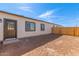 Spacious backyard featuring a newly-installed wooden fence, a stucco wall, and a brown door at 463 W Taylor Ave, Coolidge, AZ 85128