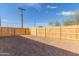 Enclosed backyard featuring a newly-installed wooden fence and plenty of space at 463 W Taylor Ave, Coolidge, AZ 85128