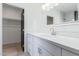 Stylish bathroom with a white vanity, modern fixtures, and an adjacent walk-in closet at 463 W Taylor Ave, Coolidge, AZ 85128