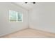 Well-lit bedroom with a large window, wood-look floors, and neutral decor at 463 W Taylor Ave, Coolidge, AZ 85128