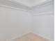 Bright walk-in closet featuring white walls, white closet rods, and wood-look floors at 463 W Taylor Ave, Coolidge, AZ 85128