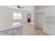 Open-concept kitchen boasts wood-look floors, modern appliances, and white cabinets at 463 W Taylor Ave, Coolidge, AZ 85128