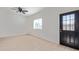 Bright living room features a black door with window, natural light, and wood-look floors at 463 W Taylor Ave, Coolidge, AZ 85128