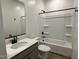 Bathroom with tub, toilet, and quartz vanity sink combo at 5628 W Summerside Rd, Laveen, AZ 85339