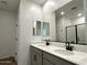 Bathroom featuring double sinks, quartz countertop, and a large vanity mirror at 5628 W Summerside Rd, Laveen, AZ 85339