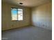 Unfinished bedroom with a large window that lets in natural light at 5628 W Summerside Rd, Laveen, AZ 85339