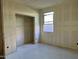 Bedroom under construction with a large closet and window, ready for customization at 5628 W Summerside Rd, Laveen, AZ 85339