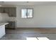 Bright living area with a window and seamless flow into the kitchen space at 5628 W Summerside Rd, Laveen, AZ 85339