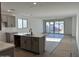 Spacious living area with modern kitchen island and large sliding doors to the patio at 5628 W Summerside Rd, Laveen, AZ 85339