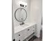 Bathroom featuring a round mirror and white vanity with quartz countertop at 5987 N 48Th Dr, Glendale, AZ 85301