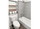 Bathroom featuring modern toilet, shelf, and tiled shower at 5987 N 48Th Dr, Glendale, AZ 85301