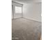 Bright bedroom with plush carpet, white walls, and a large window at 5987 N 48Th Dr, Glendale, AZ 85301