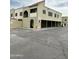 An apartment building exterior featuring tan stucco, arched entryways, and convenient parking at 5987 N 48Th Dr, Glendale, AZ 85301