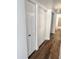 Hallway area with closet doors, clean white walls, and modern vinyl flooring at 5987 N 48Th Dr, Glendale, AZ 85301