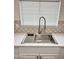 Close-up of modern kitchen sink, white countertops, and a stylish, updated faucet at 5987 N 48Th Dr, Glendale, AZ 85301