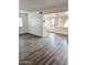 Open-concept living area with wood-look floors, white walls, and views into the kitchen at 5987 N 48Th Dr, Glendale, AZ 85301
