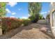 Backyard with low-maintenance gravel, blooming bougainvillea, and mature desert landscaping at 6597 N 79Th Pl, Scottsdale, AZ 85250