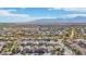 Expansive aerial view of a desert community nestled near picturesque mountains under a vast blue sky at 7038 W Beverly Rd, Laveen, AZ 85339