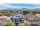 Aerial shot of backyard oasis featuring covered patio, pool and lush landscaping set against mountain backdrop at 7038 W Beverly Rd, Laveen, AZ 85339