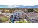 Aerial shot of backyard oasis featuring covered patio, pool and lush landscaping set against mountain backdrop at 7038 W Beverly Rd, Laveen, AZ 85339