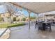Spacious backyard with covered patio area, seating, landscaping, and privacy fence at 7038 W Beverly Rd, Laveen, AZ 85339