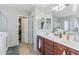 Bathroom with a double sink vanity, walk-in shower, and walk-in closet at 7038 W Beverly Rd, Laveen, AZ 85339