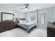 Serene bedroom with wood furniture, soft gray walls, carpet, and bright natural light at 7038 W Beverly Rd, Laveen, AZ 85339