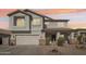 Charming two-story home featuring a two-car garage, desert landscaping, and a welcoming front porch at 7038 W Beverly Rd, Laveen, AZ 85339