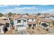 Charming two-story home showcasing a well-manicured lawn and a two car garage at 7038 W Beverly Rd, Laveen, AZ 85339