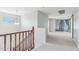 Bright hallway featuring carpeted floors and a window offering pleasant views at 7038 W Beverly Rd, Laveen, AZ 85339
