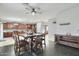 Open concept dining room with views into the large kitchen featuring an island and wooden cabinets at 7038 W Beverly Rd, Laveen, AZ 85339