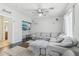 Bright open-concept living room featuring large sectional sofa and media center at 7038 W Beverly Rd, Laveen, AZ 85339