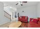 Inviting living room with two sofas, ceiling fan, and staircase leading to the upper level at 7038 W Beverly Rd, Laveen, AZ 85339