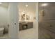 Elegant bathroom featuring marble floors, neutral vanity with seated makeup area, and storage at 7175 E Camelback Rd # 401, Scottsdale, AZ 85251