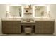 Well-lit bathroom featuring dual vanity, makeup area, sleek finishes, and marble flooring at 7175 E Camelback Rd # 401, Scottsdale, AZ 85251
