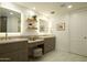 Bright bathroom showcases double vanity, marble floors, modern fixtures, and ample cabinet space at 7175 E Camelback Rd # 401, Scottsdale, AZ 85251