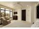 Bright bedroom featuring a neutral palette, large windows, and cozy armchair at 7175 E Camelback Rd # 401, Scottsdale, AZ 85251