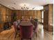 Luxurious dining room featuring hardwood floors, wood paneled walls and a gorgeous chandelier lighting the space at 7175 E Camelback Rd # 401, Scottsdale, AZ 85251