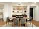 Dining room with wood table and chairs, stylish lighting, and a built-in bar area with shelving at 7175 E Camelback Rd # 401, Scottsdale, AZ 85251