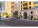 Grand entrance to a building with lush landscaping, patterned driveways, and easy access at 7175 E Camelback Rd # 401, Scottsdale, AZ 85251