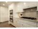 The kitchen features stainless steel appliances, custom cabinetry, and marble countertops at 7175 E Camelback Rd # 401, Scottsdale, AZ 85251