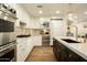 Gourmet kitchen with stainless steel appliances, marble countertops, and custom white cabinets at 7175 E Camelback Rd # 401, Scottsdale, AZ 85251