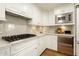 Gourmet kitchen featuring stainless steel appliances, marble backsplash, and custom cabinets at 7175 E Camelback Rd # 401, Scottsdale, AZ 85251