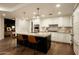 Gourmet kitchen with stainless steel appliances, custom cabinetry, and a center island with seating at 7175 E Camelback Rd # 401, Scottsdale, AZ 85251