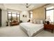 Serene main bedroom showcases large windows, neutral tones, a seating area, and ample natural light at 7175 E Camelback Rd # 401, Scottsdale, AZ 85251