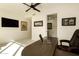 Large home office featuring a dark wood desk, carpeted flooring, and a mounted television at 7175 E Camelback Rd # 401, Scottsdale, AZ 85251